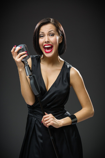 Female musician handing microphone - Fotó, kép
