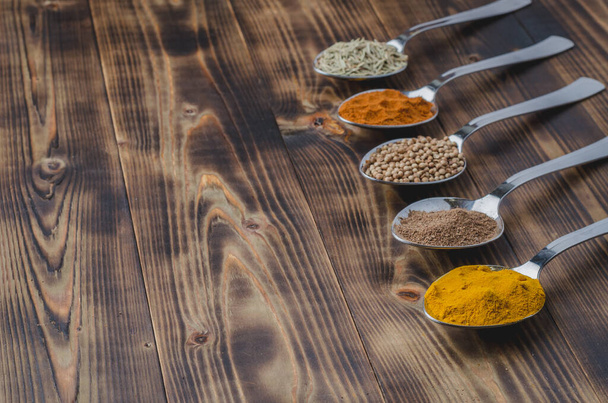 Colourful various spices on a wooden table, copyspace - Zdjęcie, obraz
