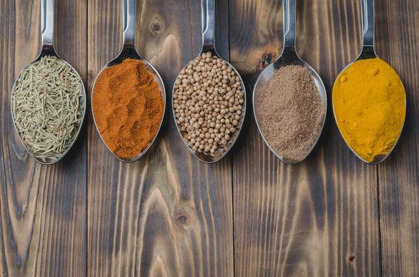 various spices in spoons on a wooden table, top view Ingredients for cooking - Foto, immagini
