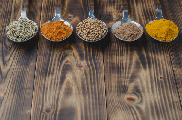 Colourful various spices on a wooden table, copyspace - Фото, зображення