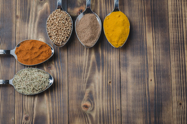 Set of various aromatic colorful spices on a wooden table. Top view and copyspace. Ingredients for cooking - Fotoğraf, Görsel