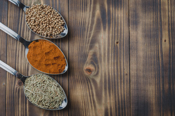 Set of various aromatic colorful spices on a wooden table. Top view and copyspace. Ingredients for cooking - Foto, afbeelding