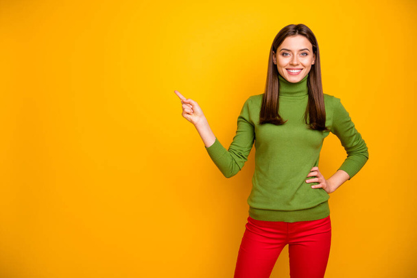 Portrait of positive cheerful cool girl promoter point index finger copy space recommend adverts promotion wear casual style clothing isolated over yellow color background - Φωτογραφία, εικόνα