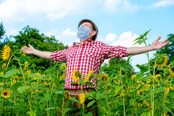 bavarian man wearing a protective mask and standing outdoors in nature - Foto, Imagen