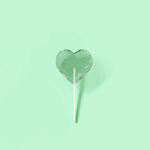 Crack  Candy Heart on green color background. Minimal valentine concept ideas. 3D Render - Foto, afbeelding