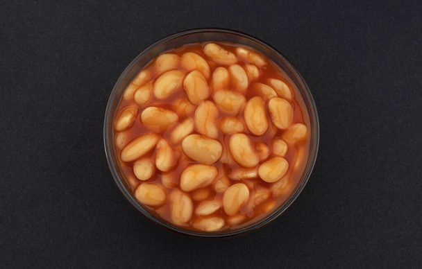 Baked beans in tomato sauce on black background, top view - Photo, image