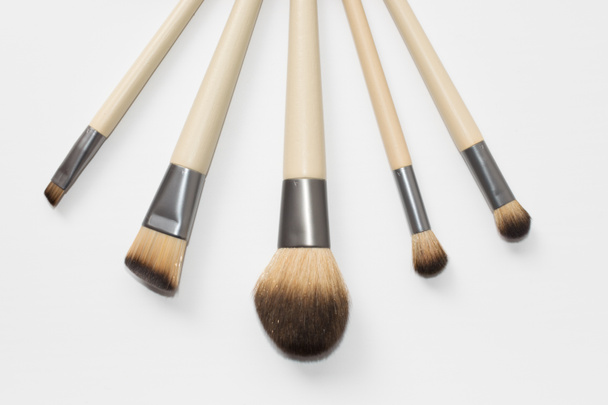 Collection of brown makeup brushes on a white background - Photo, Image