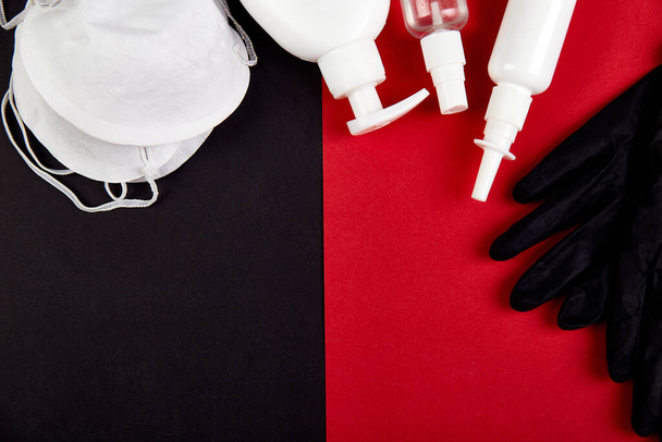 Flat lay of Coronavirus protection, medical protective masks, gloves, hand sanitizer bottles - Foto, imagen