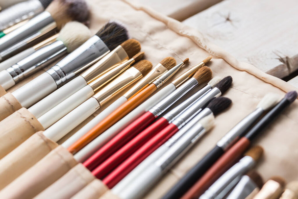 Makeup, beauty and cosmetics concept - Set of make-up brushes in a light case. - 写真・画像