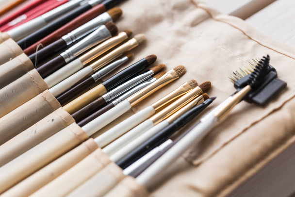 Makeup, beauty and cosmetics concept - Set of make-up brushes in a light case. - Foto, Imagen