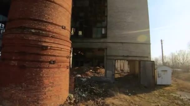 FPV drone flies quickly and maneuverable through an abandoned construction at sunset - Felvétel, videó
