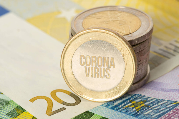 Euro banknotes and coins and corona virus - Foto, afbeelding
