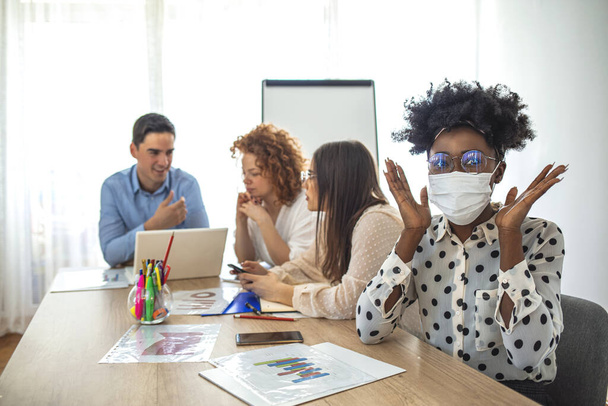 Employees working in business office while wearing medical face mask for protecting and preventing the infection of corona virus disease or covid-19. Business people fearing swineflu virus - Foto, afbeelding