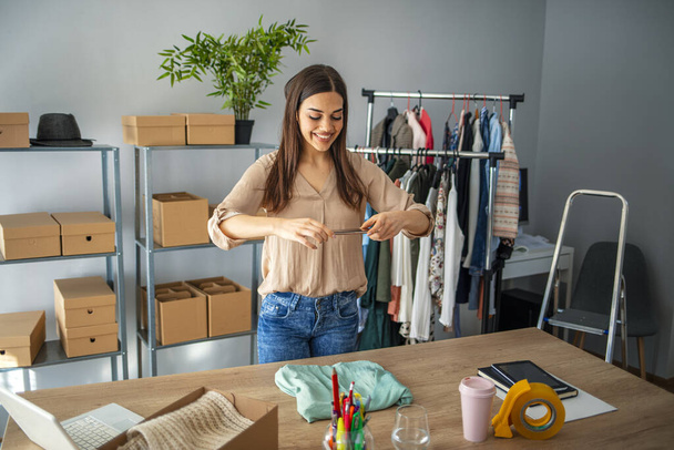 Online seller owner. Online shopping. Business Start up SME concept. Young startup entrepreneur small business owner working at home, packaging and delivery situation. - 写真・画像
