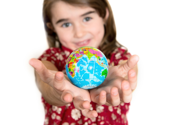 Cute lgirl holding little World Globe on her Hands - Foto, imagen