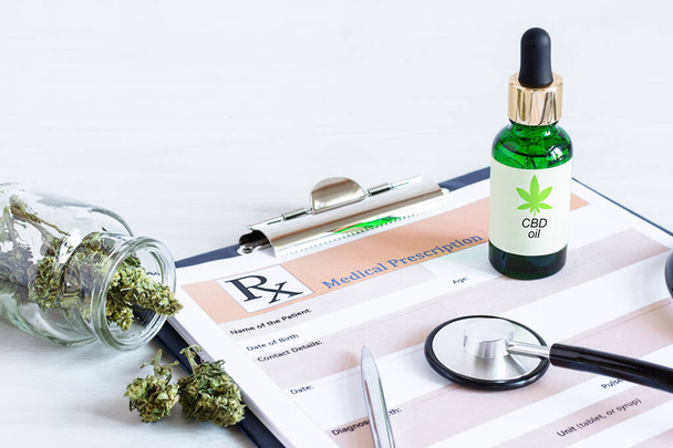 Bottle of Cbd oil, cannabis seeds and dry leaves over medical prescription sheet top view on white wooden table. Medical marijuana, alternative medicine concept. - Фото, зображення