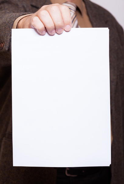 Businessman holding blank sheet of paper. Business concept. - Foto, Bild