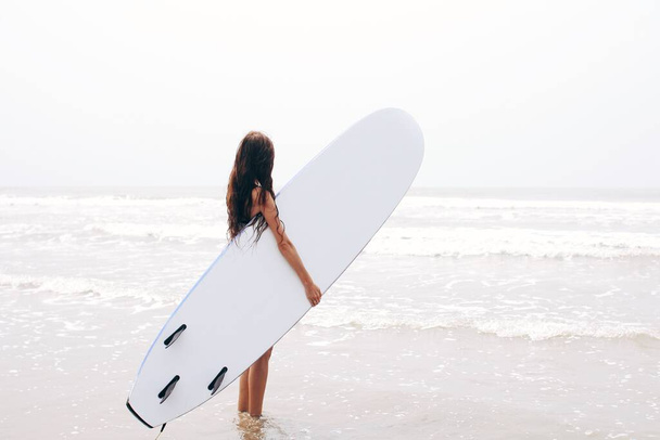 Surfer girl by the ocean, GOA - Photo, image