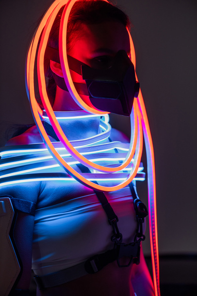 futuristic african american woman in respirator and neon lighting - Photo, Image
