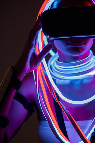 futuristic african american woman in vr headset and neon lighting - Photo, image