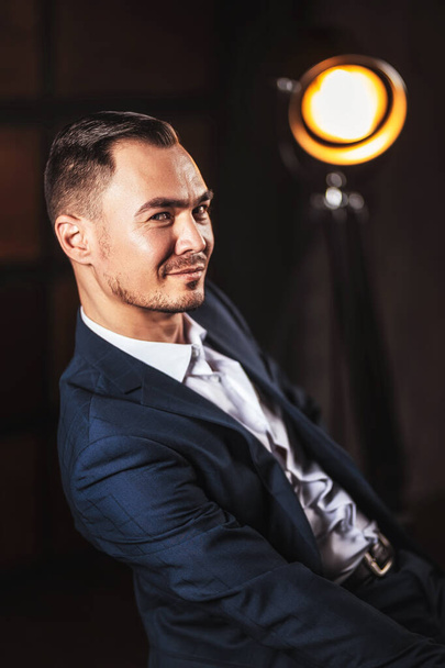 Portrait of a man in a white shirt and suit on a dark background. Beautiful sexy and a stylish man with a playful smile. Young businessman Asian business man - Foto, afbeelding