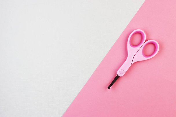small pink closed scissors for baby care. pink Studio background. the concept of cutting children's nails. - Foto, Imagen