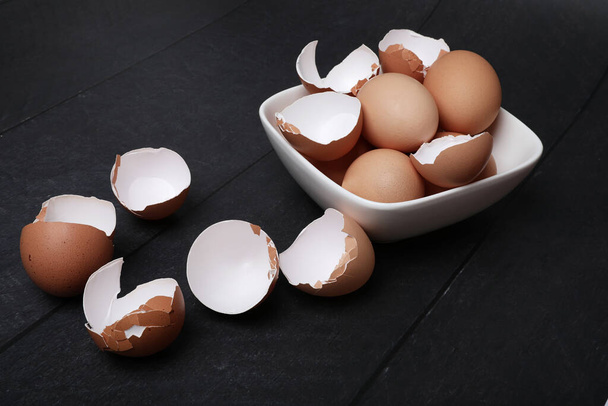 Many eggs on the table for cooking. Baking ingredients on wooden table. - Φωτογραφία, εικόνα