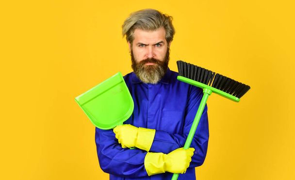 Garbage removal. Cleaning day. Janitor professional. Bearded hipster blue uniform with broom. Gardener cleaning service man. Cleaning agency. Worker with brush. Cleaning equipment. Yardman occupation - Foto, afbeelding