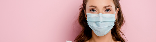 panoramic shot of girl in medical mask isolated on pink  - Fotó, kép