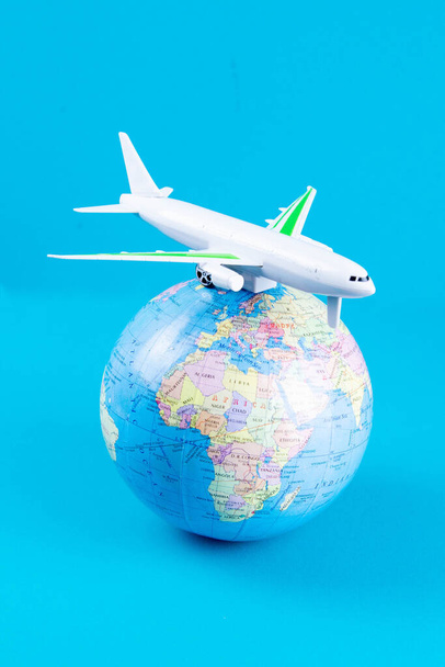 Plastic toy plane on the globe. Flight travel concept. Travel by airplane. Takeoff and landing of the aircraft. Return home from flight. empty Copy space. - Фото, зображення