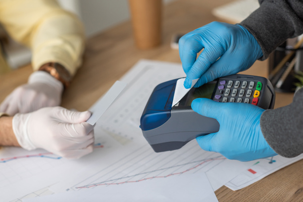 cropped view of delivery man holding payment terminal and credit card near businessman  - Photo, Image