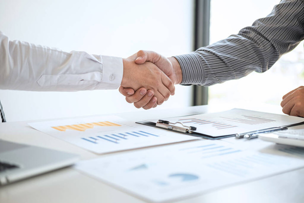 Finishing up a meeting collaboration, handshake of two business people after contract agreement to become a partner, collaborative teamwork. - Photo, Image