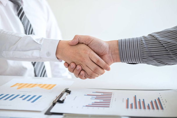 Finishing up a meeting collaboration, handshake of two business people after contract agreement to become a partner, collaborative teamwork. - Photo, Image