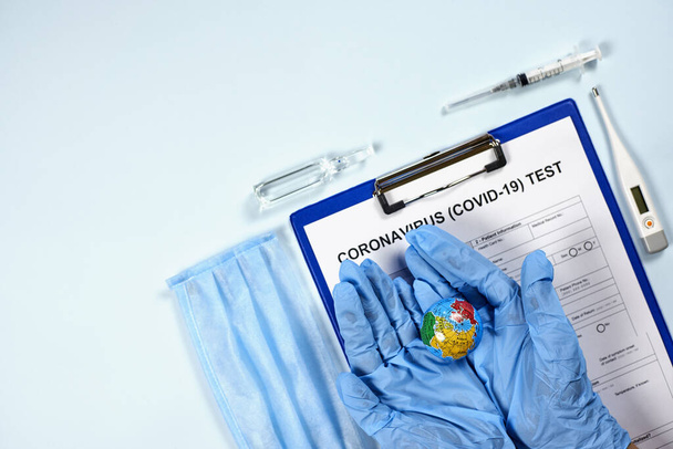 Coronavirus test form. Getting the COVID-19 test. Testing for 2019-ncov. Medical test form for new corona virus with medical supplies and equipment - thermometer, syringe, globe and ampule - Photo, image