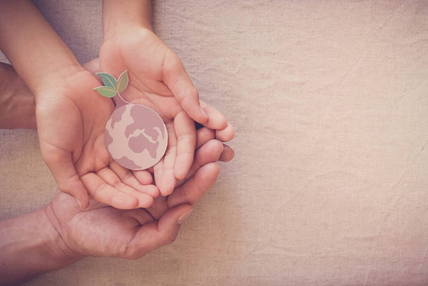 Hands holding growing tree on earth, save planet, earth day, ecology environment, climate emergency action, csr social responsibility, sustainable living concept - Photo, Image