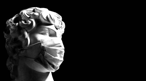 Koronavirüs. Tıbbi maskeli genç adam, mesaj için uygun bir yer. Koruyucu maskeli bir heykel çağdaş bir sanattır. Avrupa 'da Kovid-19. Tıbbi maske - Hastalıkların önlenmesi - Fotoğraf, Görsel