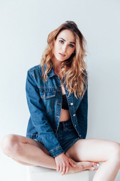 portrait of a beautiful woman in a denim jacket and shorts - Photo, Image