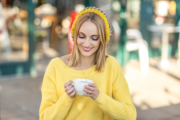 a young woman enjoying a coffee - 写真・画像