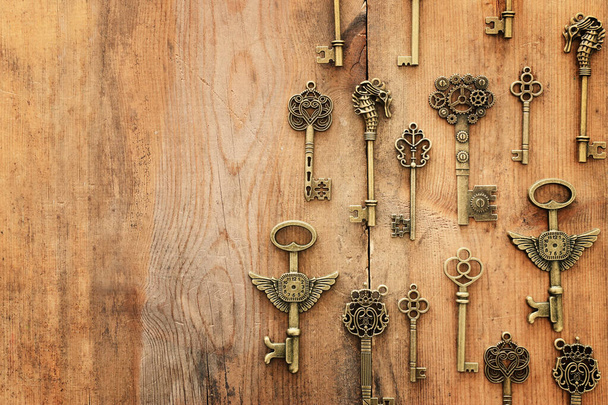 Image of old antique keys over wooden background. Top view, flat lay - Photo, Image