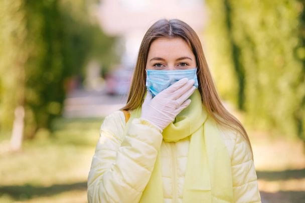 woman wearing face mask during corona virus and flu outbreak. Disease and illness protection. Surgical masks for coronavirus prevention. Sick patient coughing - Фото, изображение