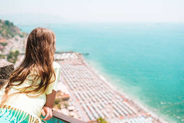 Young girl in background of mediterranean sea and sky. - Photo, Image