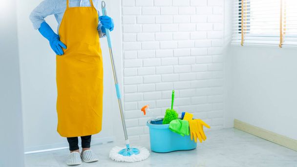Young housekeeper or washing cleaning floor at mop in protective gloves, Housework Cleaning service - Photo, Image