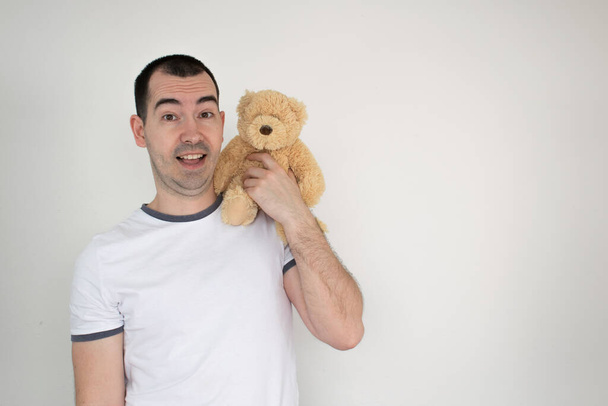 adult attachment white background male stand hold bear closeup happy tshirt man - Photo, Image