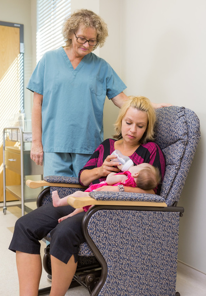Nurse Looking At Woman Feeding Newborn Babygirl On Chair - Fotó, kép