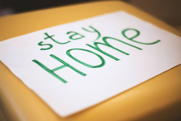 A white paper with stay home written on it - Foto, Imagem