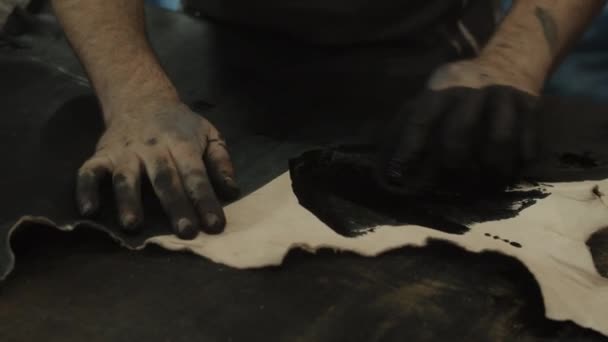 SLOW MOTION: CLOSE UP OF SOMEONE TRADITIONALLY COLORING LEATHER OLD PRODUCTION  - Footage, Video