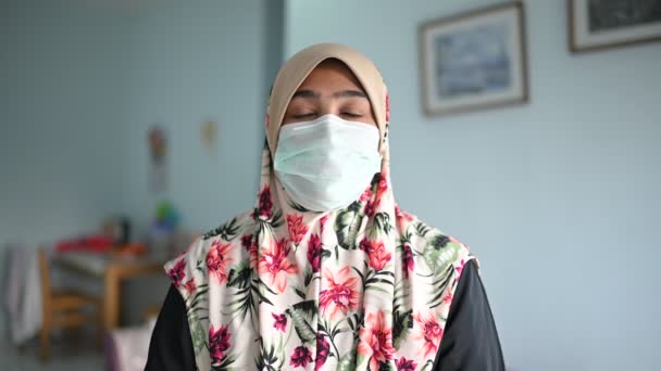 Koncept koronaviru a znečištění ovzduší pm2.5. mladá krásná muslimka v lékařské masce, dívá se do kamery. Zdravotní péče a lékařská koncepce. - Záběry, video