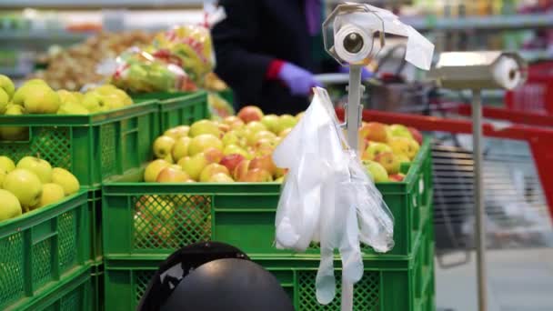 Disposable plastic gloves in fruit department at grocery store - Video, Çekim