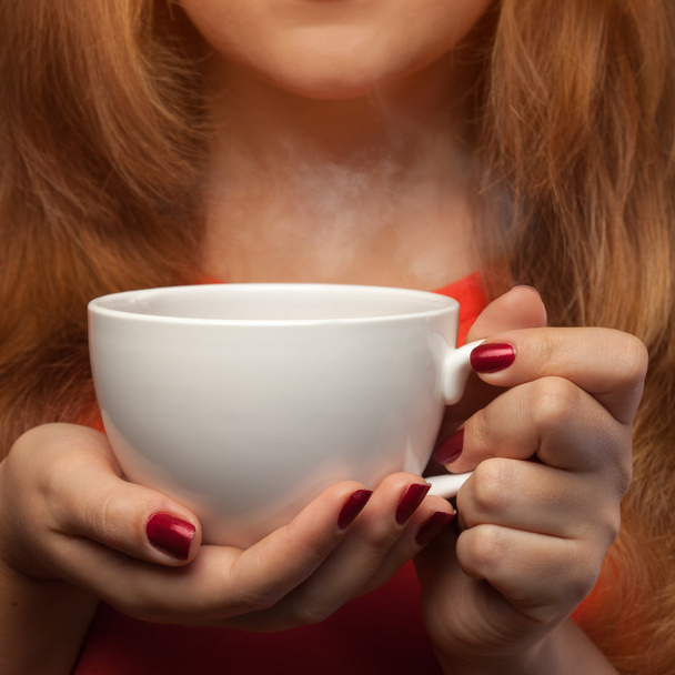 woman holding hot cup - Фото, изображение