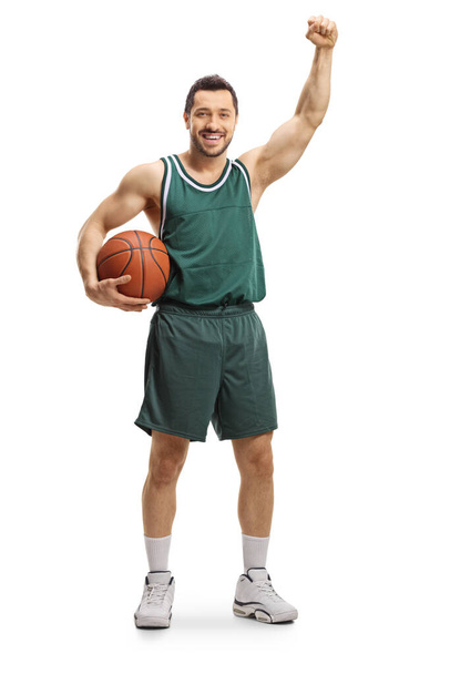 Full length portrait of a basketball player gesturing win with hand isolated on white background - 写真・画像